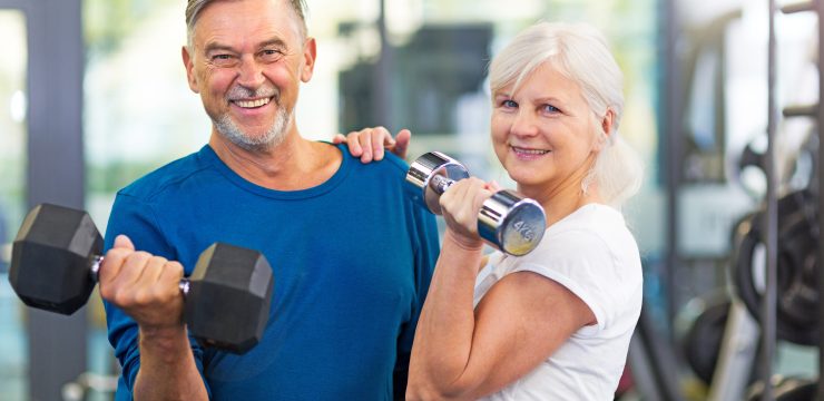 Senior,Couple,Exercising,In,Gym