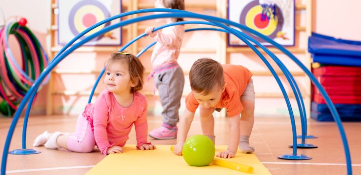 Nursery,Babies,Playing,Together,In,Kindergarten,Gym